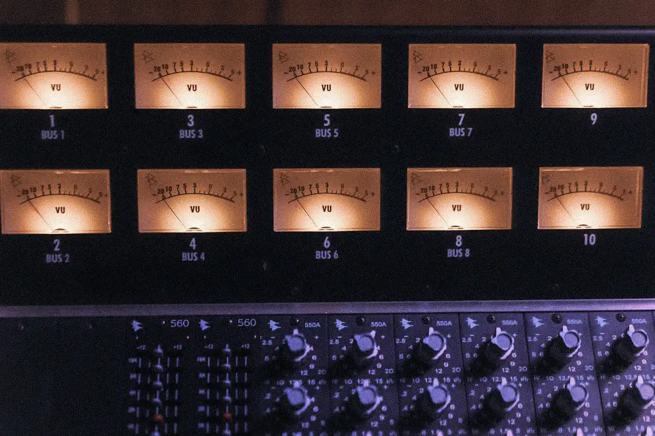 A grainy image of the VU meters of an old mixing console