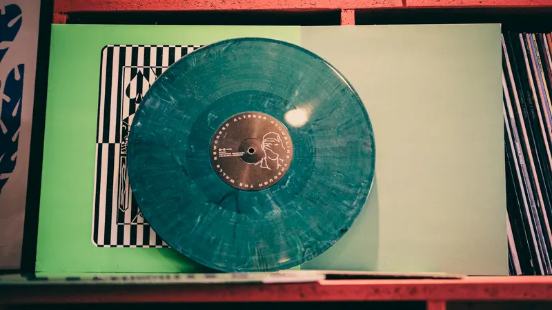 A green record leaning up against some green record covers
