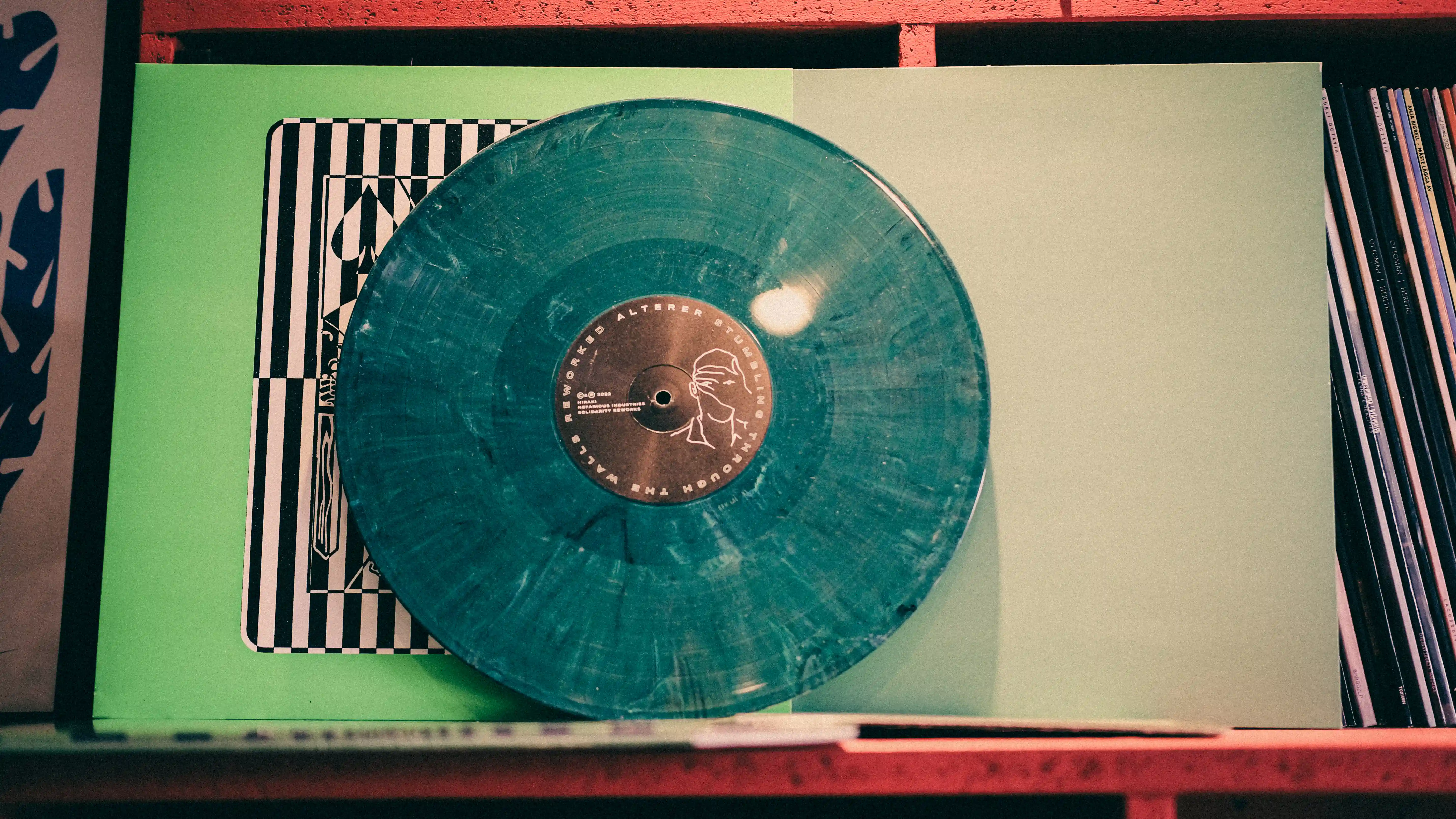 Mathias, RPM Records COO, inspecting a record he just pressed
